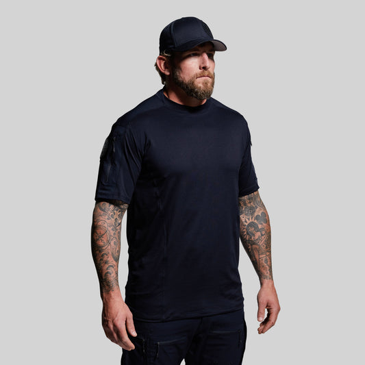 Man wearing a blue t-shirt and cap on a gray background