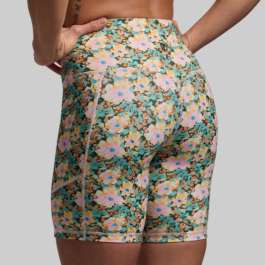Floral patterned shorts worn by a person on a plain background