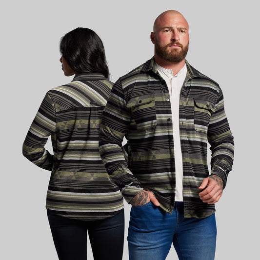 Two people wearing striped shirts against a gray background