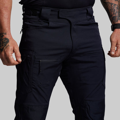 Blue tactical pants worn by a person on a plain background