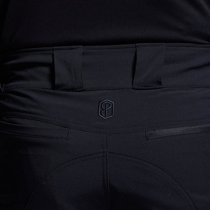 Close-up of blue pants with a brand logo on the waistband.