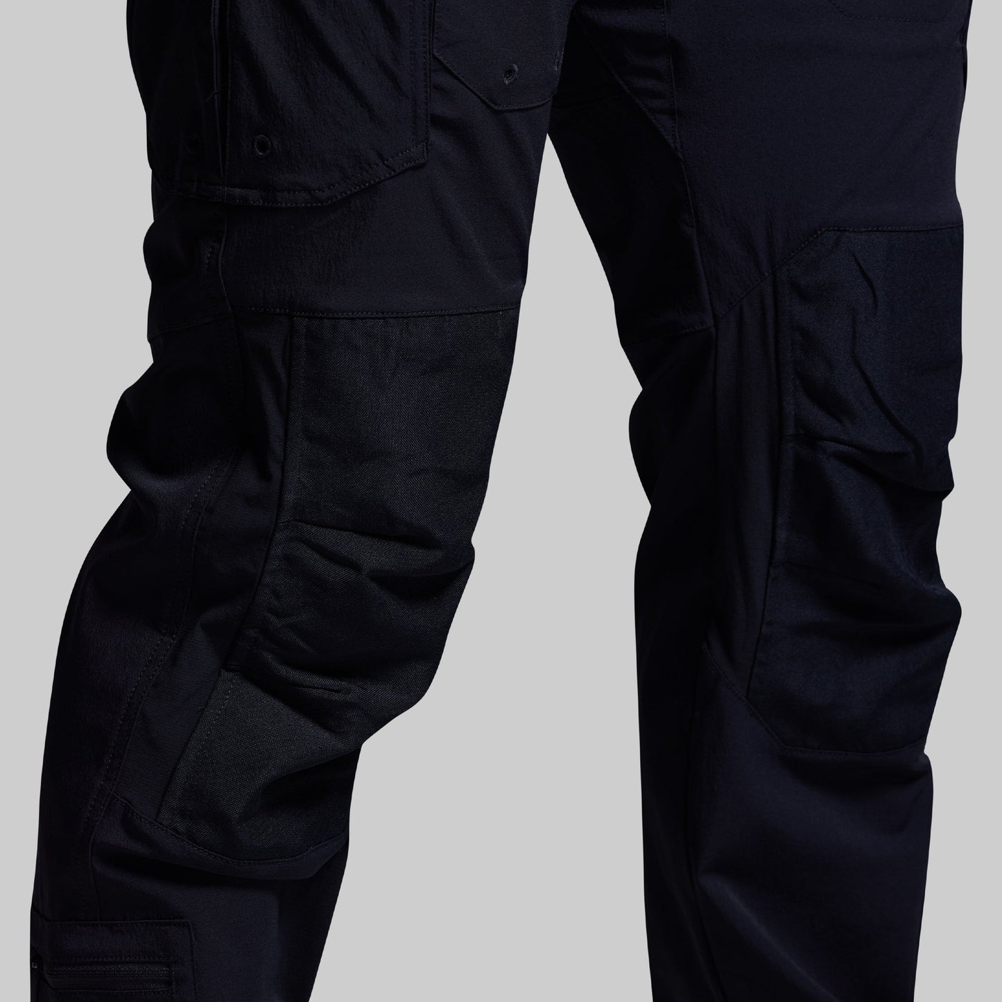 Blue tactical pants on a gray background