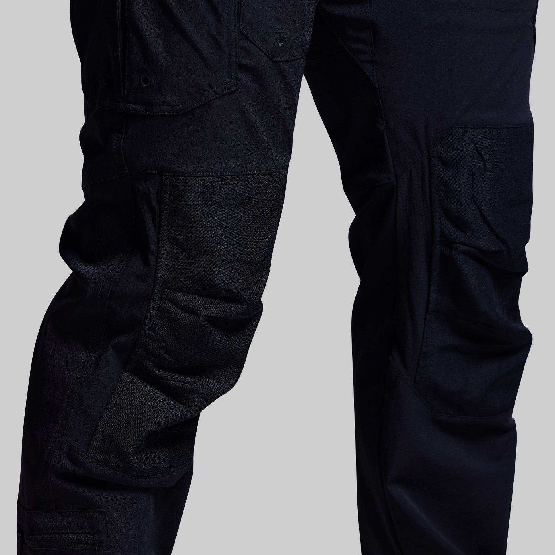 Blue tactical pants on a gray background