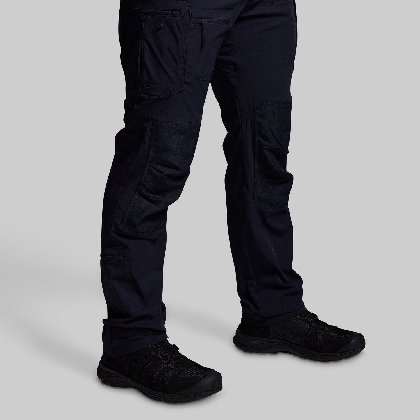 Blue pants and black shoes on a light gray background