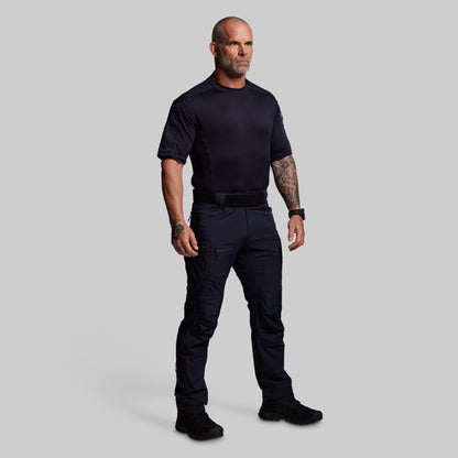 Man wearing a blue tactical outfit on a gray background