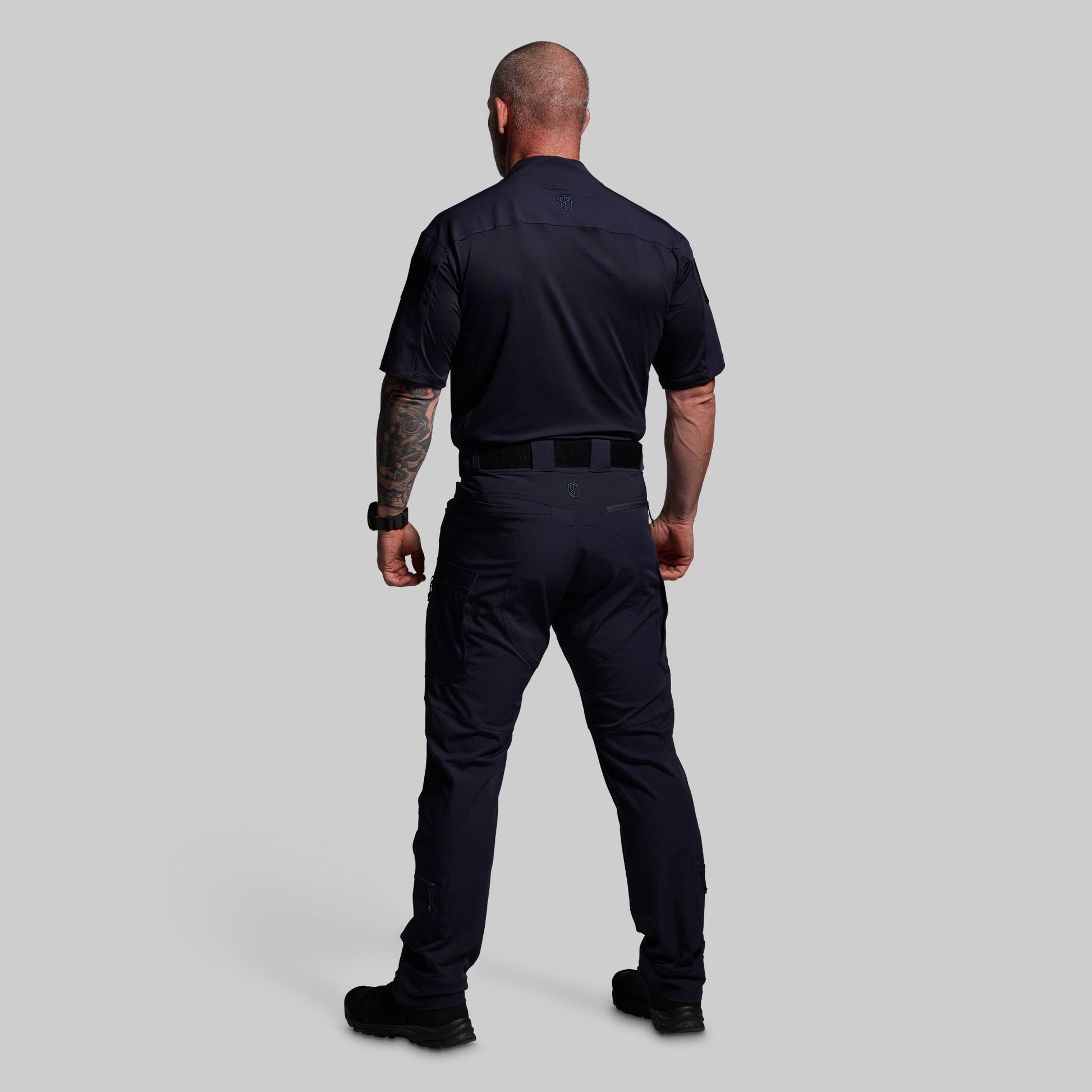 Person wearing a blue uniform on a gray background