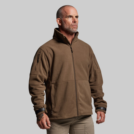 Man wearing a brown jacket on a gray background