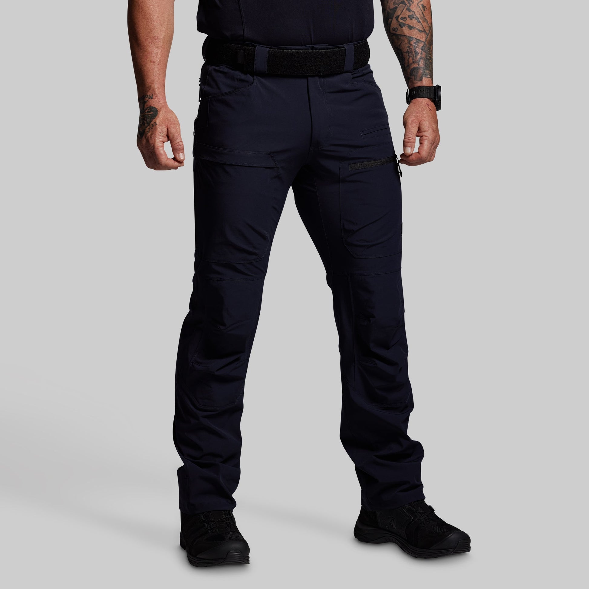 Person wearing blue outdoor pants on a gray background