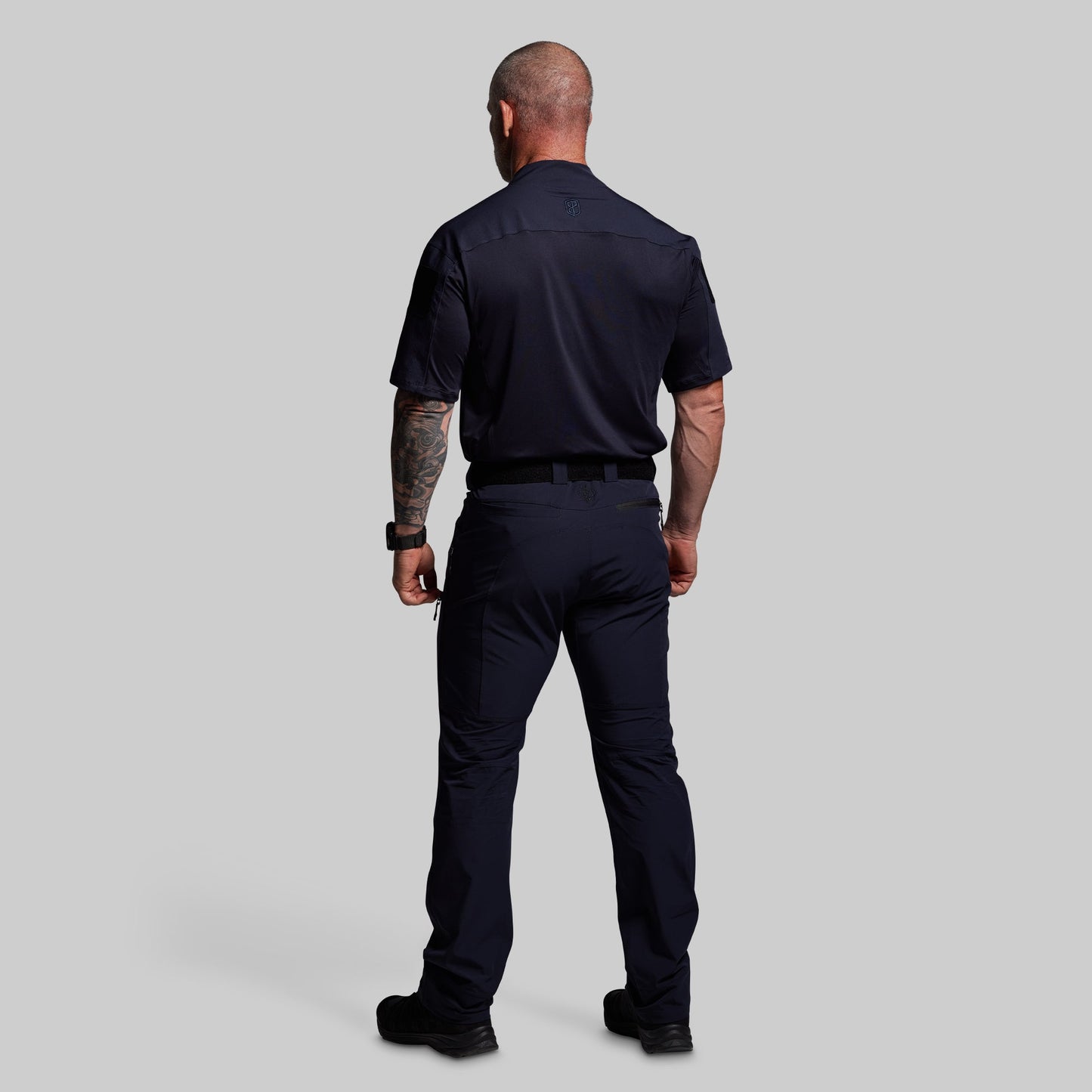 Person wearing a blue uniform on a gray background