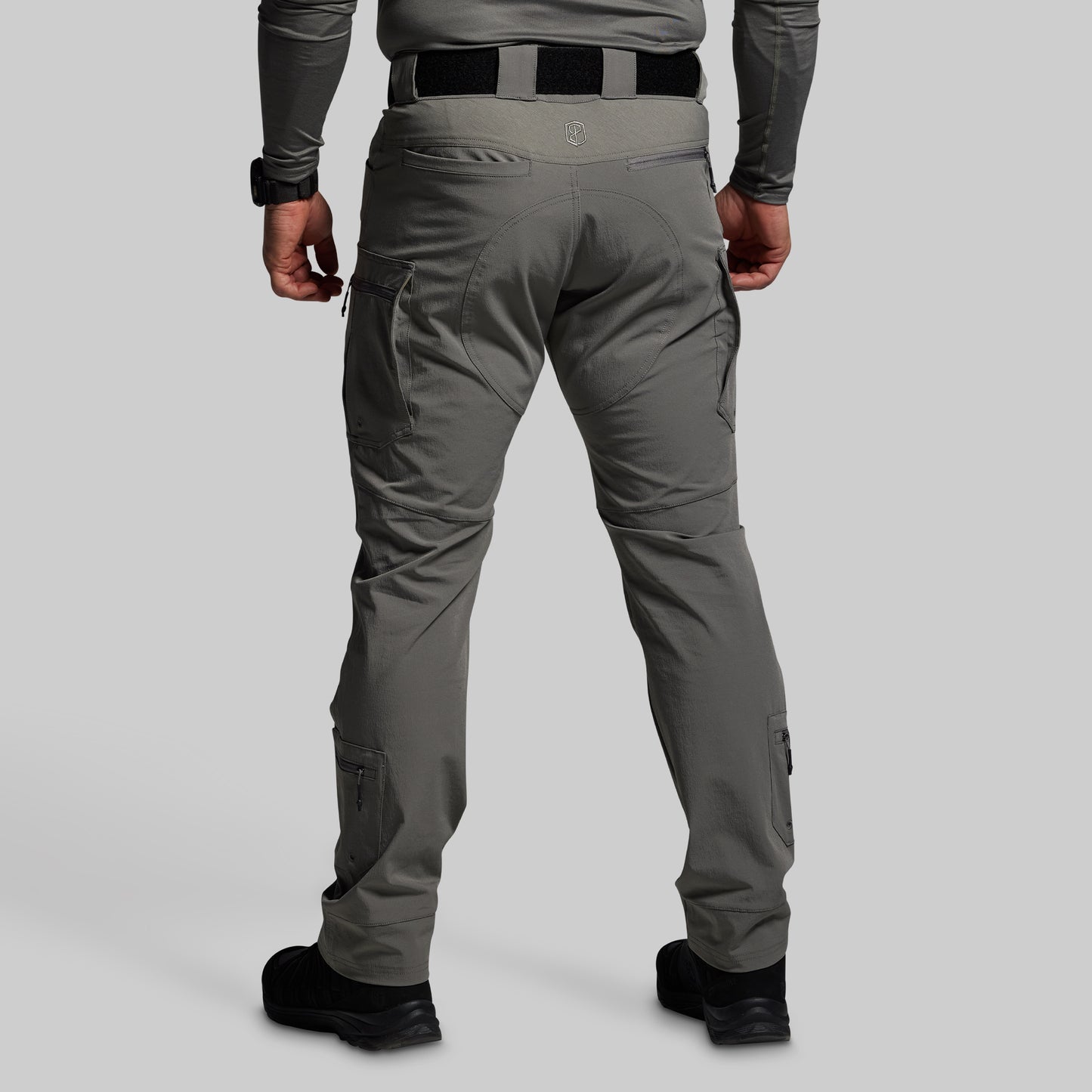 Gray tactical pants worn by a person on a light gray background