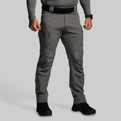 Person wearing gray tactical pants on a light gray background