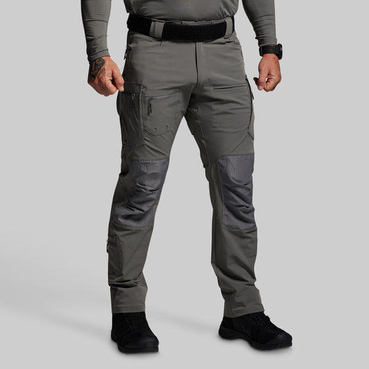 Person wearing gray tactical pants on a light gray background