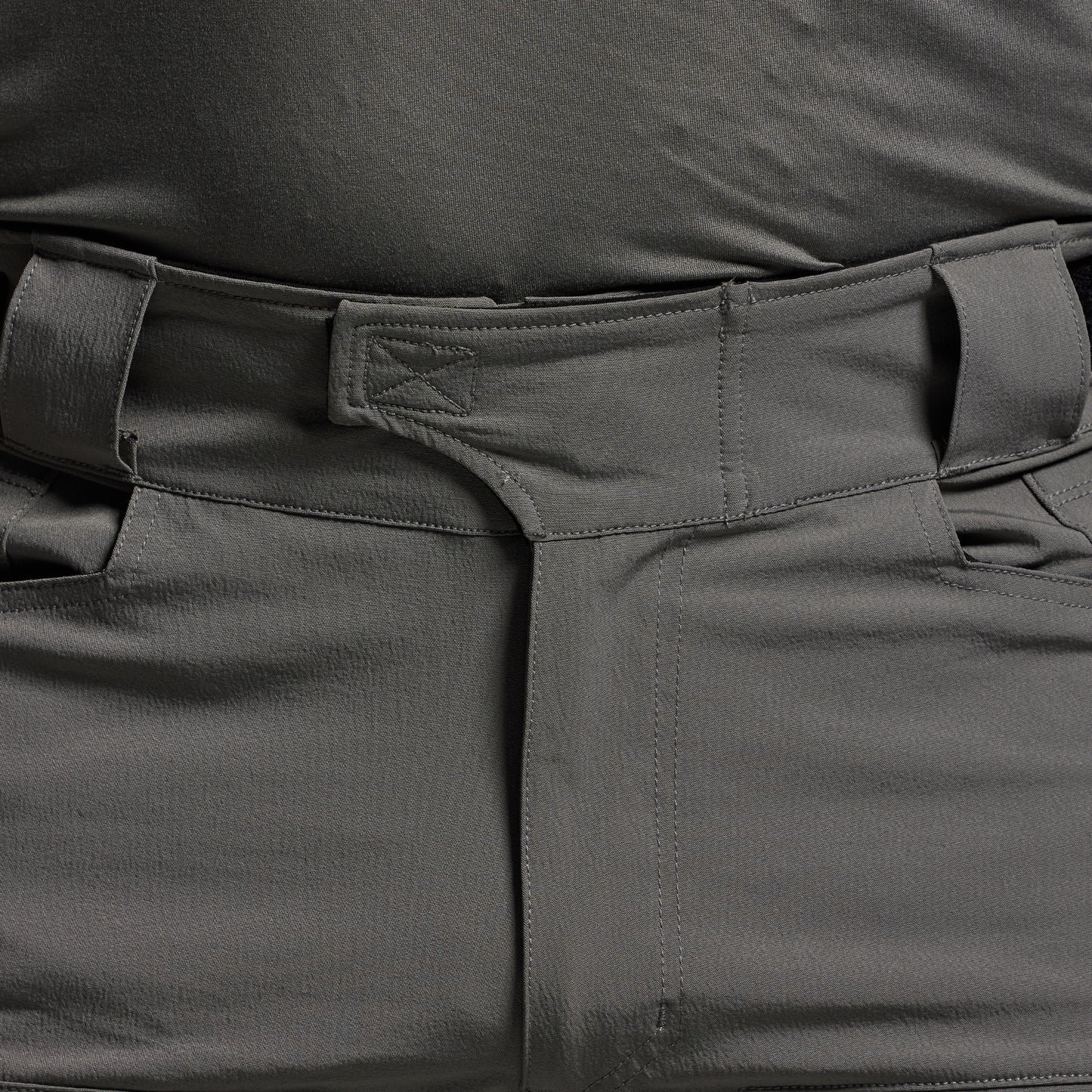 Close-up of dark gray tactical pants with multiple pockets.
