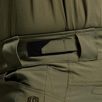 Close-up of green tactical pants with a focus on the adjustable waistband.