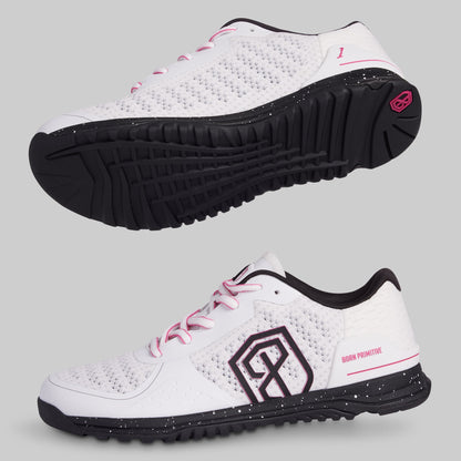 White athletic shoes with black soles and pink accents on a gray background