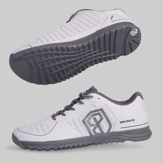 White athletic shoes with gray accents on a light gray background