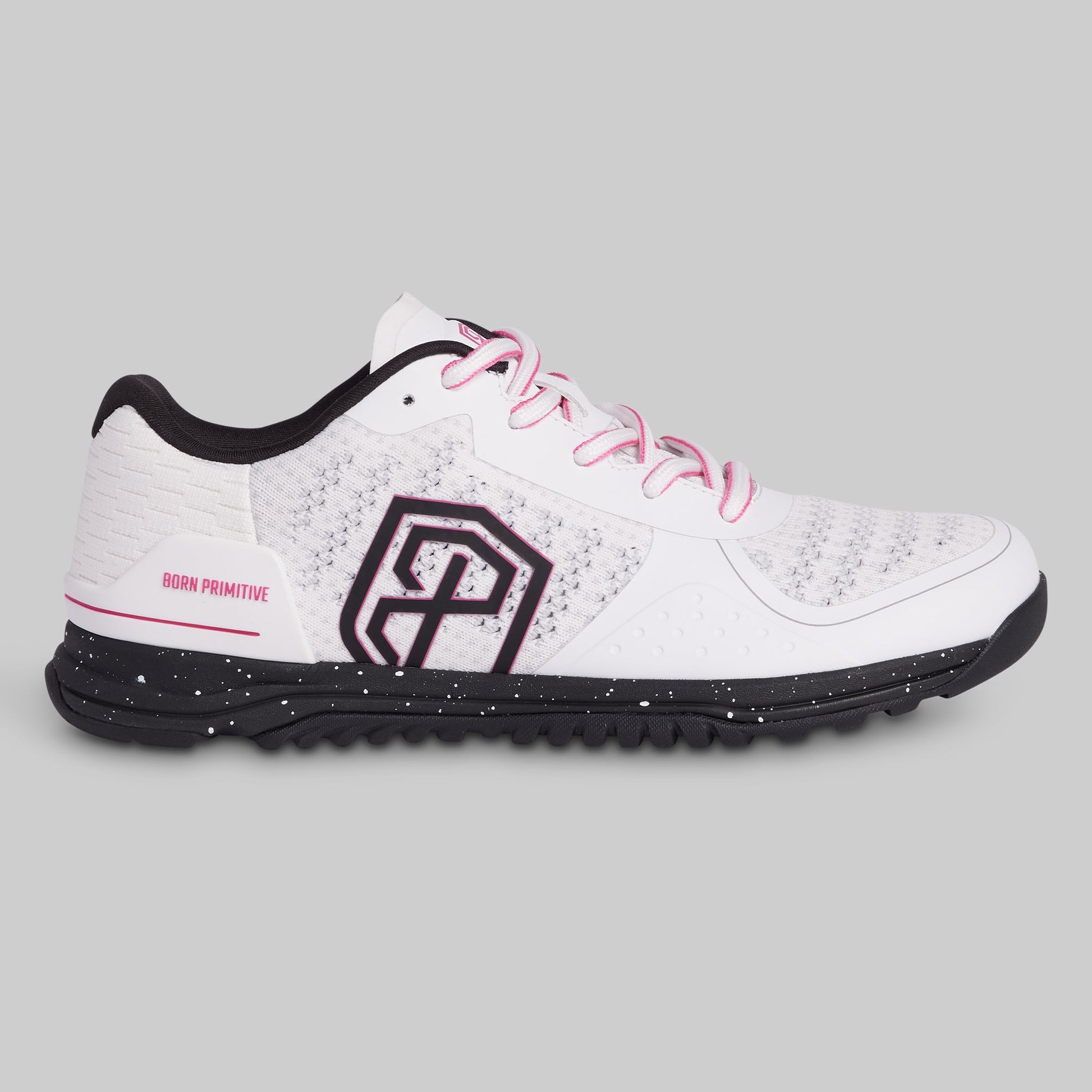 White athletic shoe with black sole and pink laces on a gray background