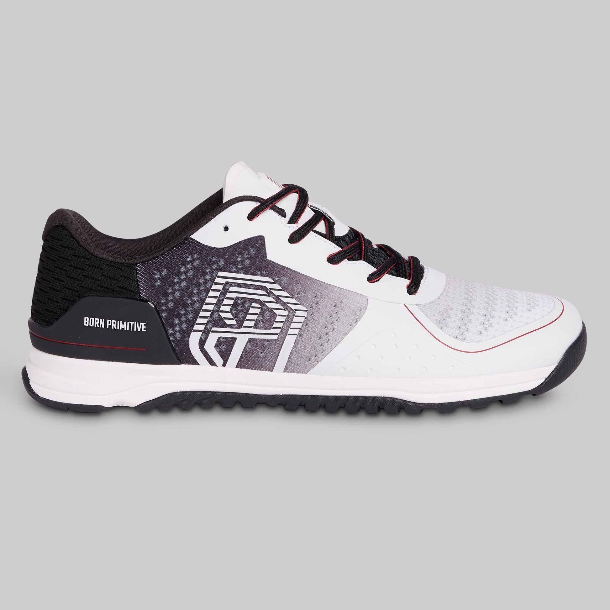 White and black athletic shoe with red accents on a gray background
