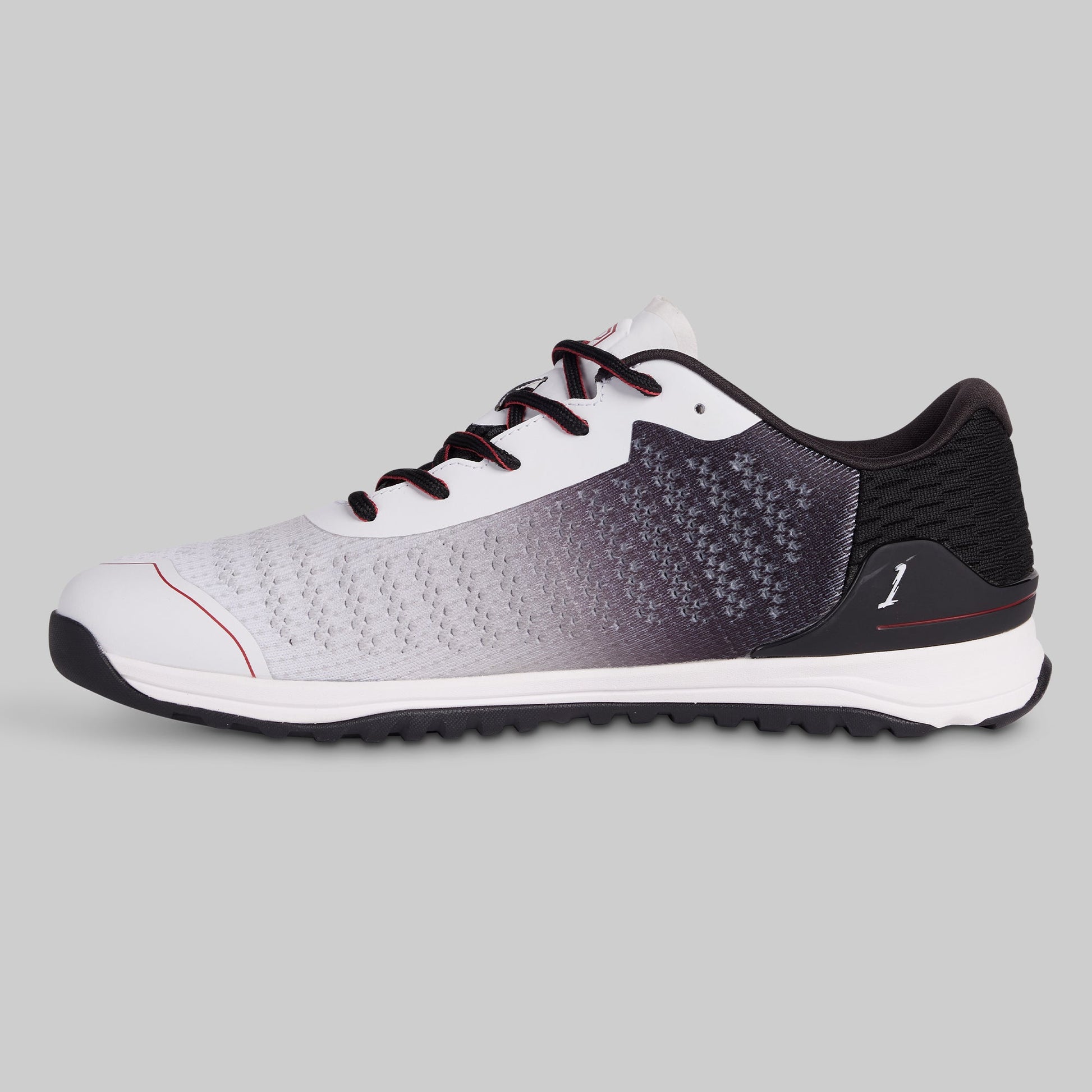 Athletic shoe with white, black, and gray gradient on a gray background