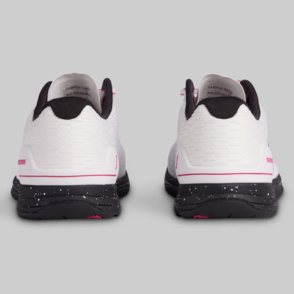 White sneakers with black and pink accents on a gray background