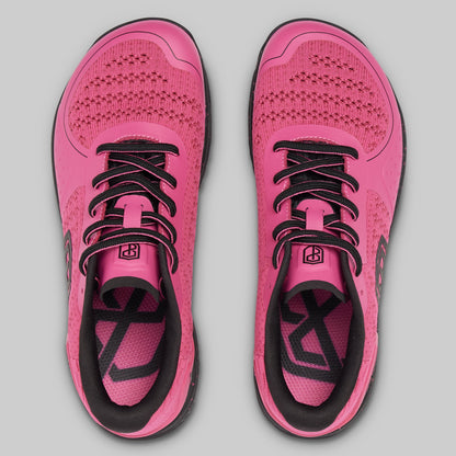 Pair of pink running shoes with black accents on a gray background