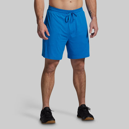 Person wearing blue shorts on a gray background