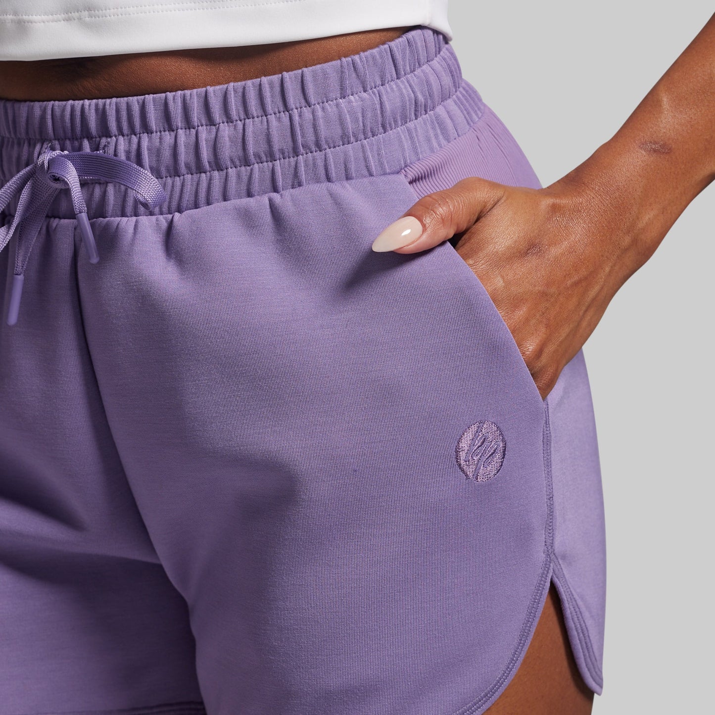 Purple shorts with a brand logo on a gray background