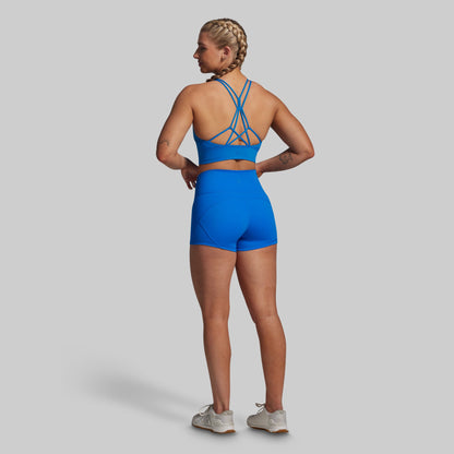 Person wearing a blue sports outfit on a gray background