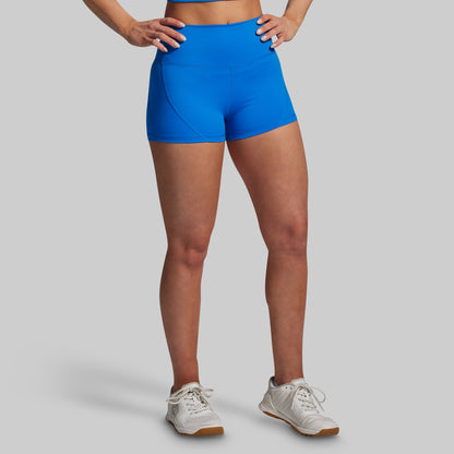 Person wearing blue athletic shorts on a gray background