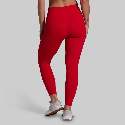 Red leggings worn by a person on a gray background
