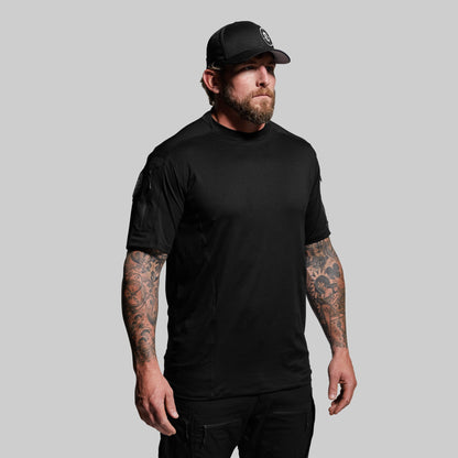 Man wearing a black t-shirt and cap on a gray background