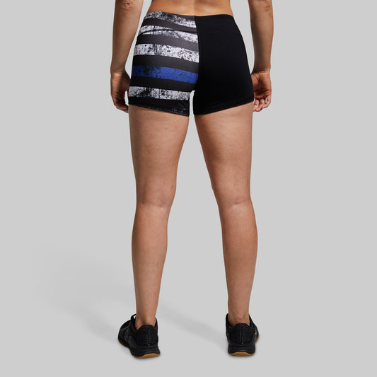 Person wearing black and gray striped shorts on a gray background