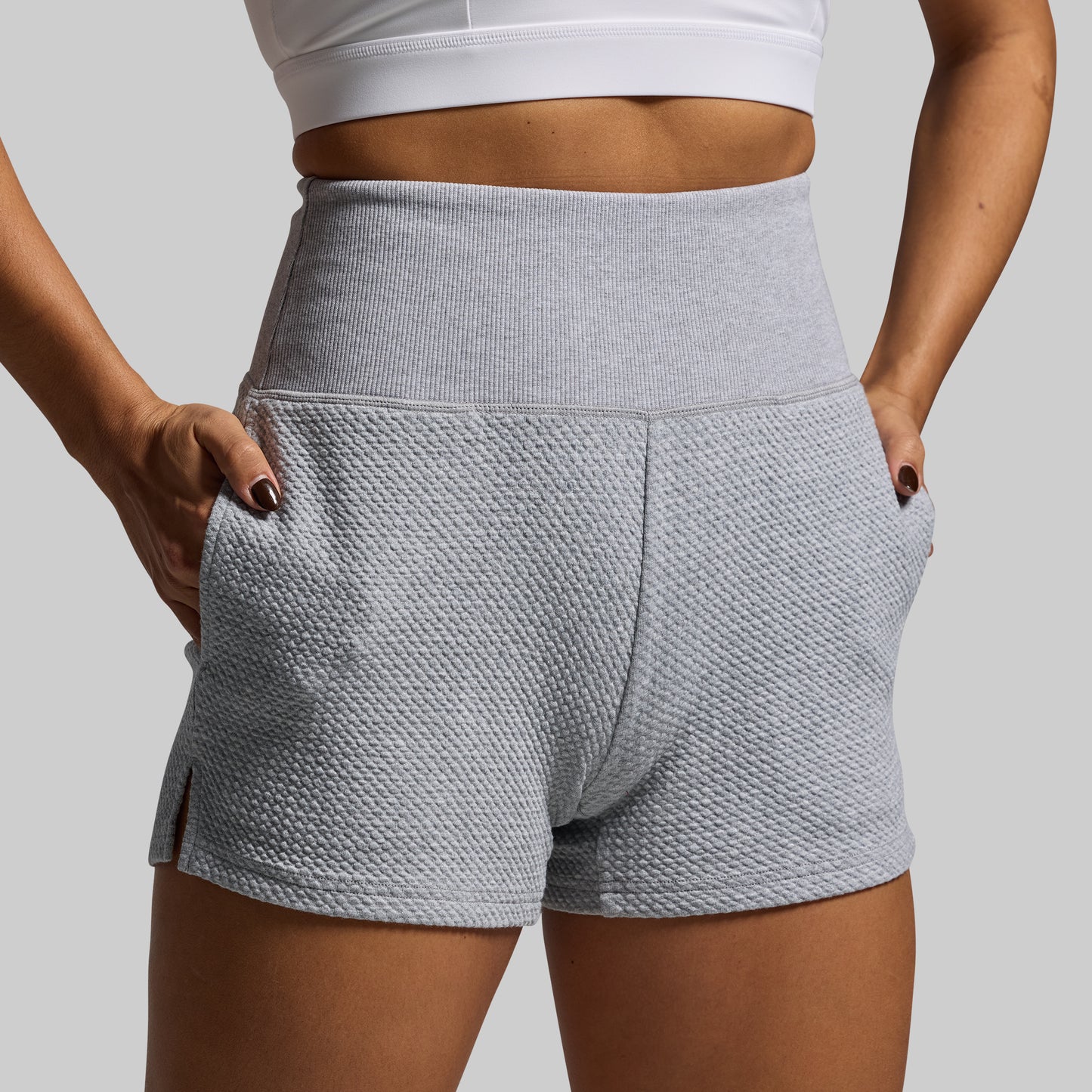 Gray textured shorts worn by a person on a plain background