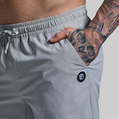 Gray athletic shorts with a brand logo on a neutral background