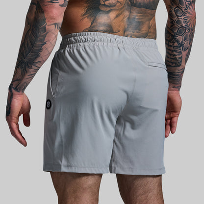 Gray athletic shorts worn by a person with tattoos on a gray background
