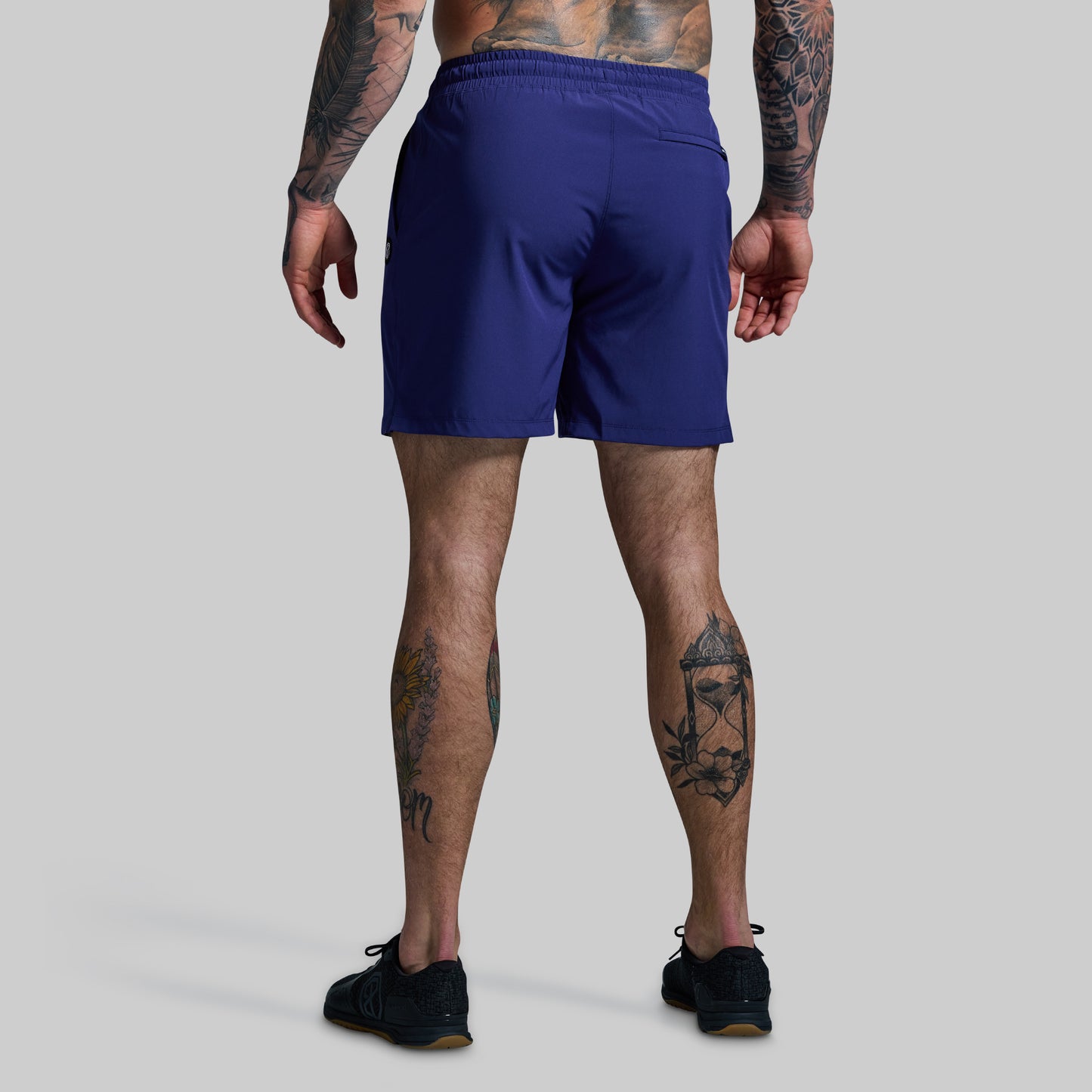 Person wearing blue shorts on a gray background