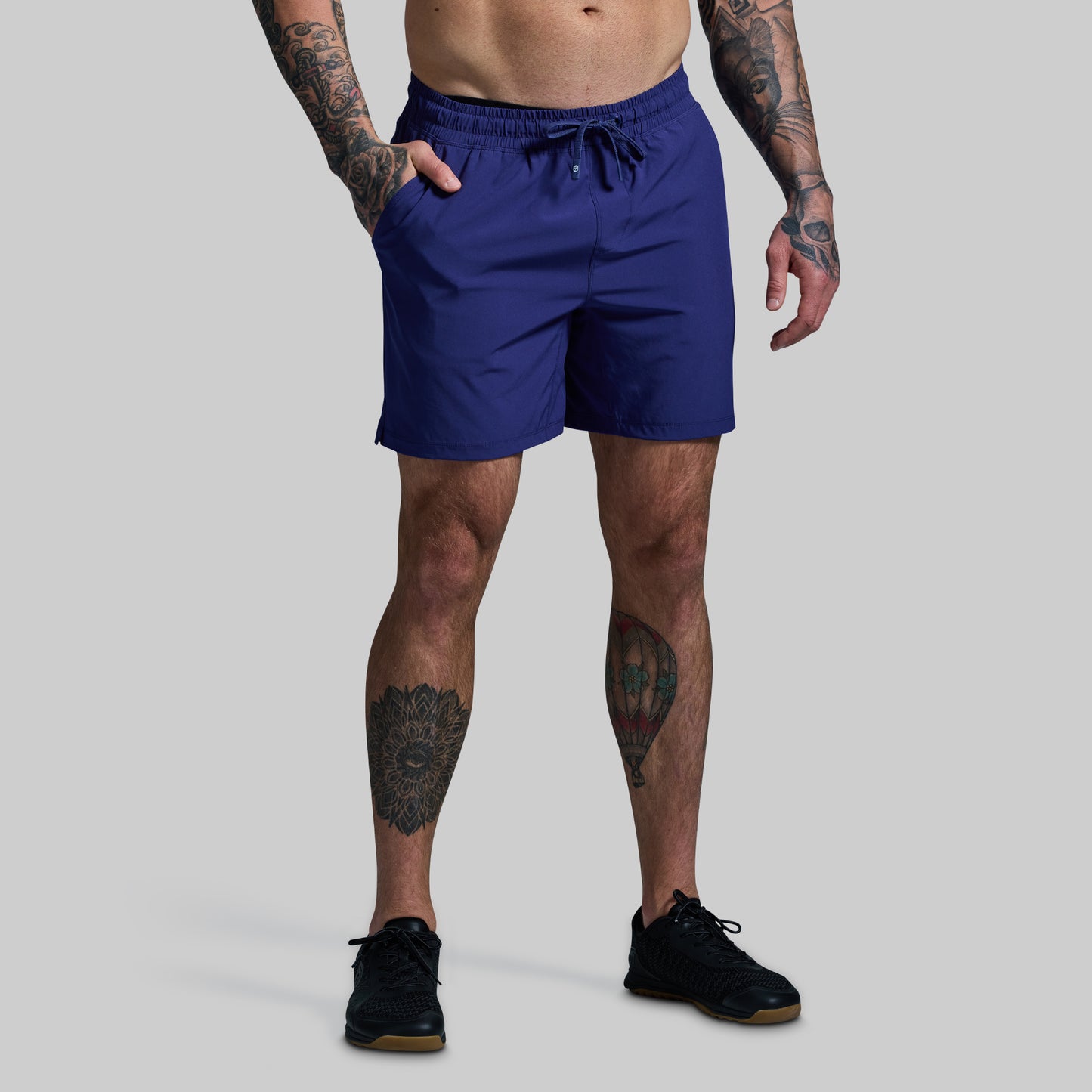 Person wearing blue shorts on a gray background