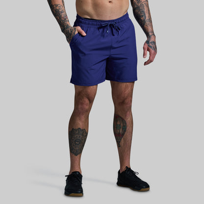 Person wearing blue shorts on a gray background