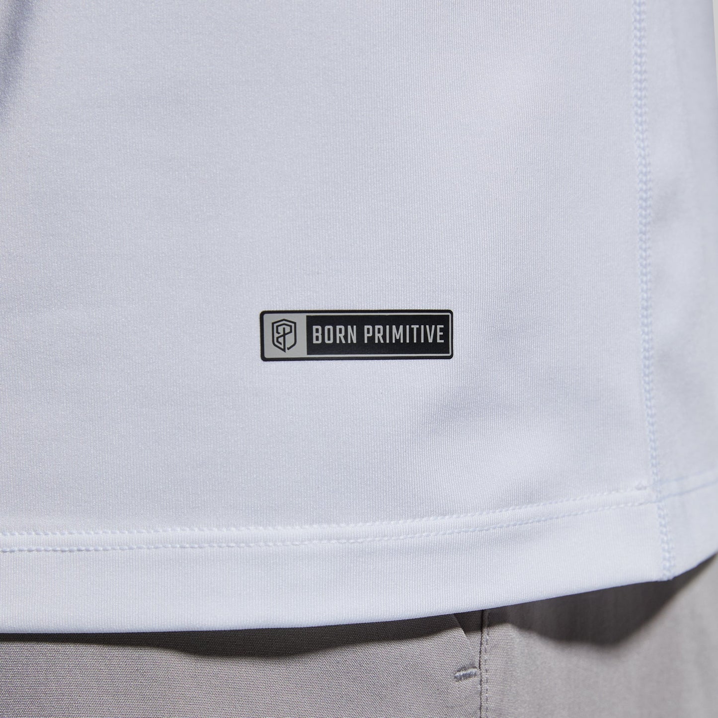 Close-up of brand logo on a white t-shirt.