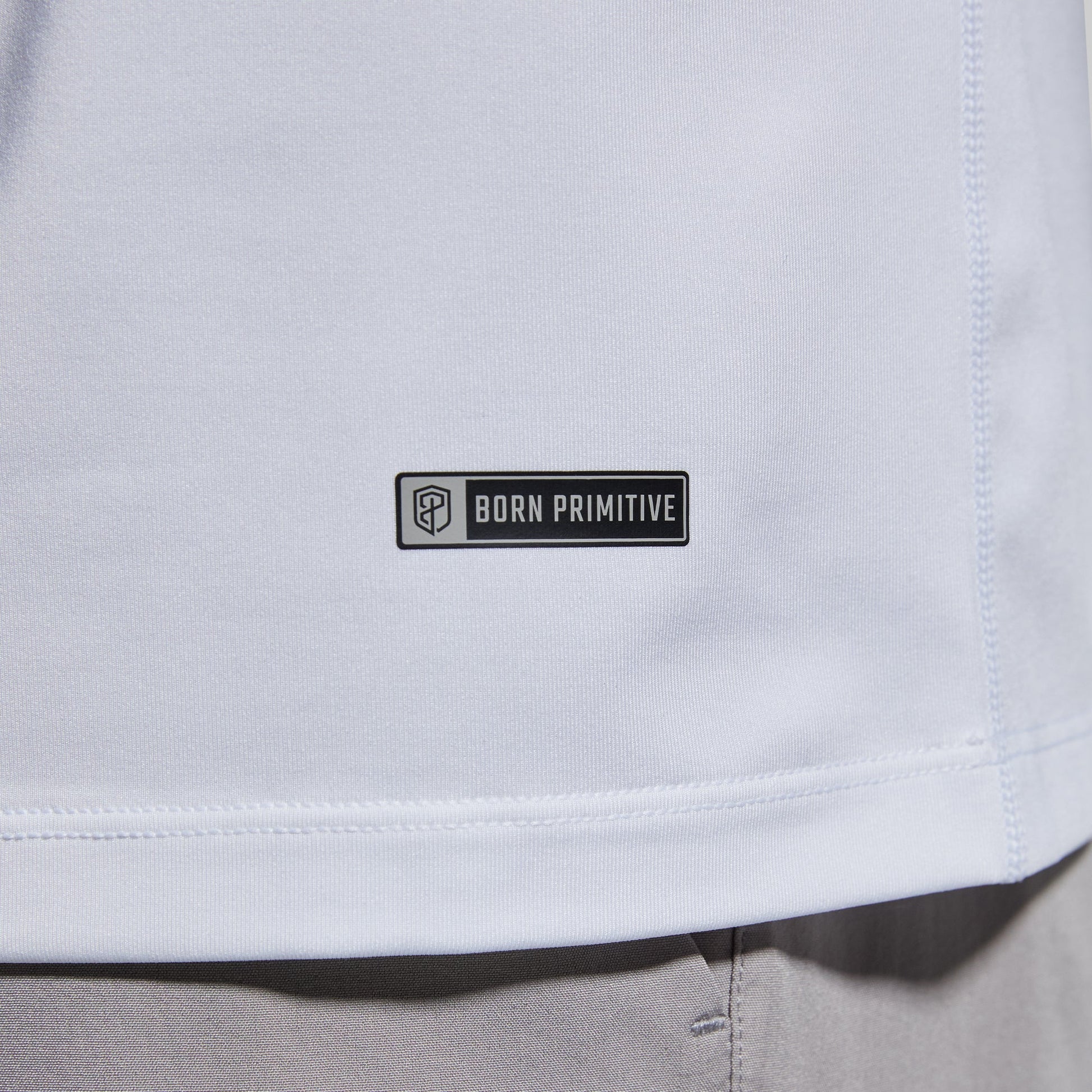 Close-up of brand logo on a white t-shirt.