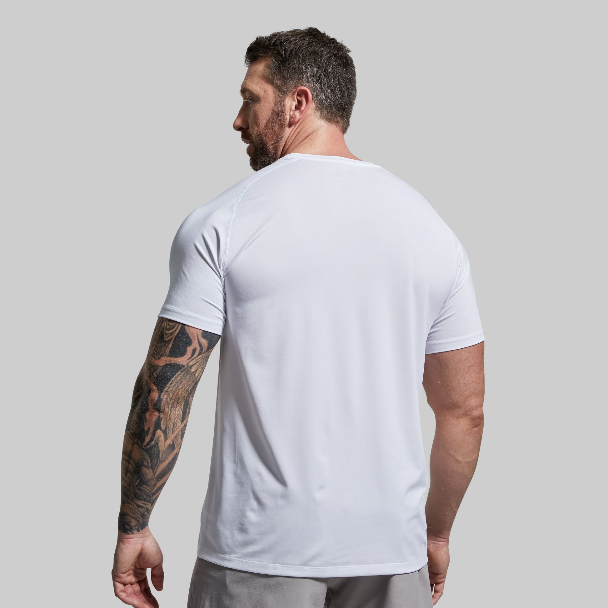 Man wearing a white t-shirt against a plain background