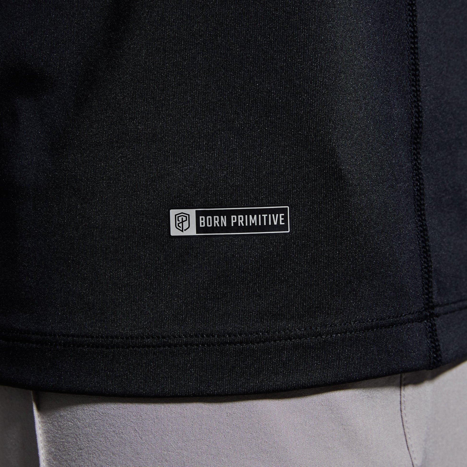 Close-up of brand logo on a black t-shirt.