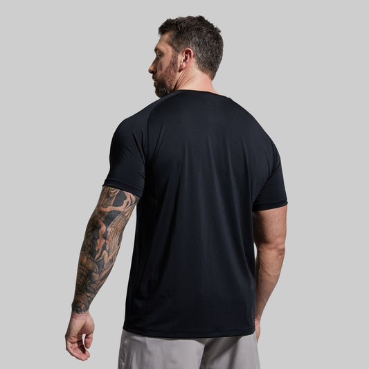 A man wearing a black short-sleeved t-shirt.