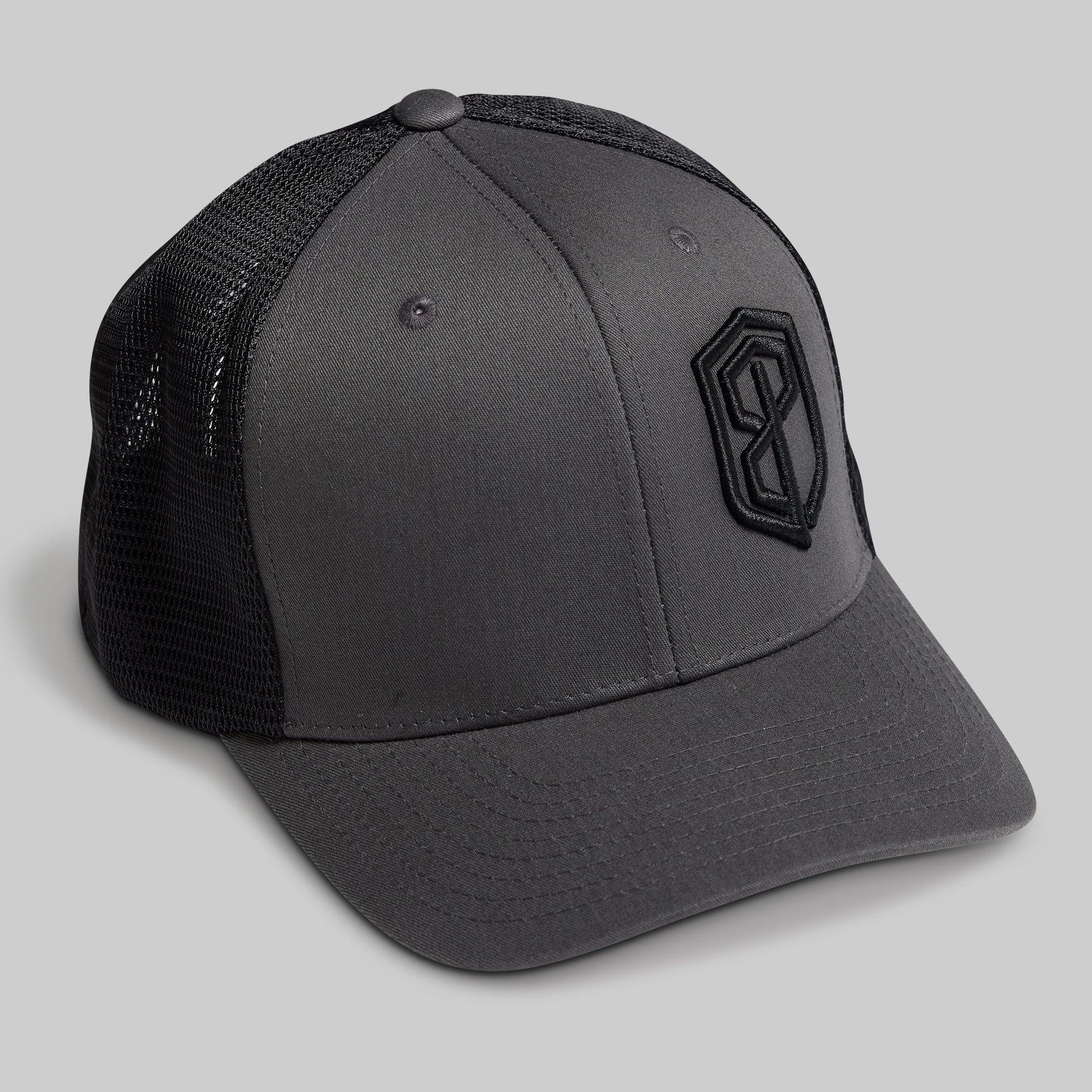 Gray cap with black mesh back and logo on a light gray background