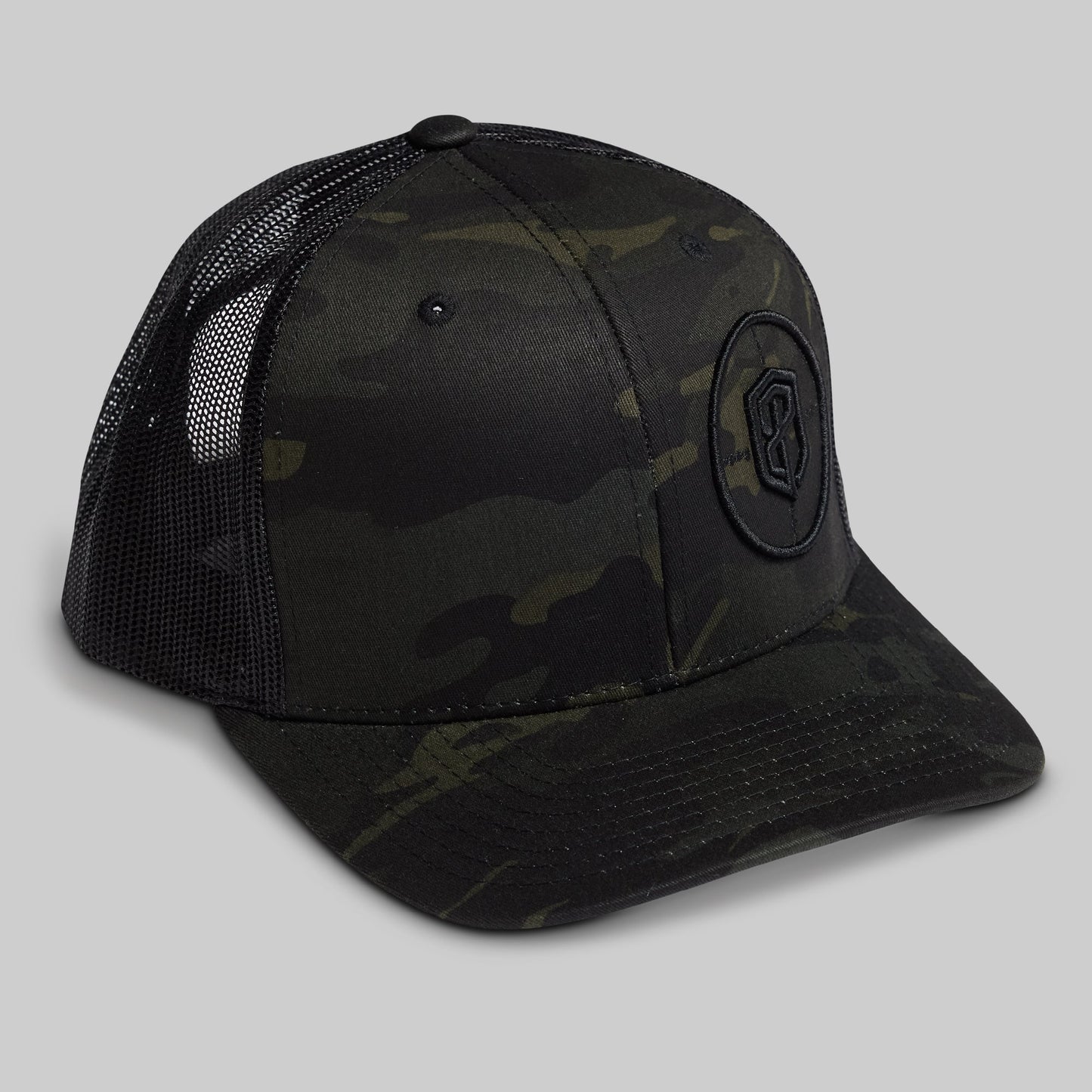 Black camouflage baseball cap with a logo on a gray background