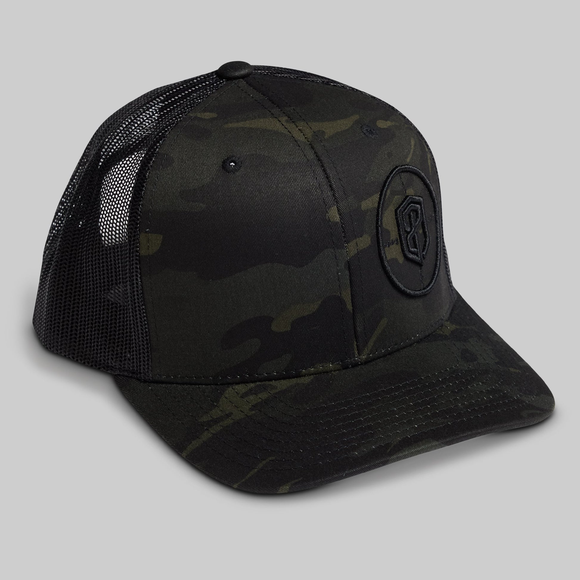 Black camouflage baseball cap with a logo on a gray background
