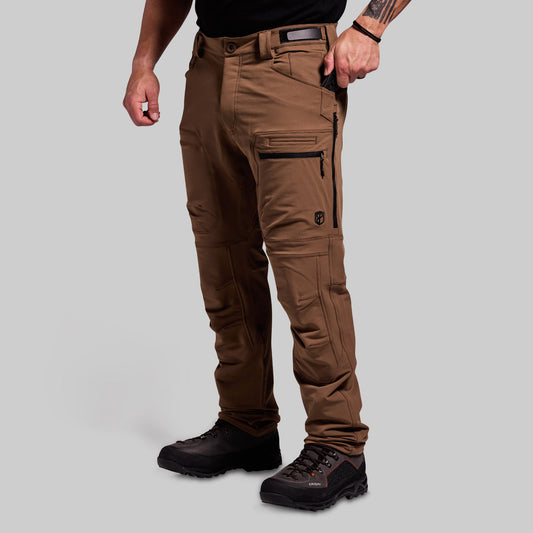 Brown outdoor pants worn by a person on a gray background