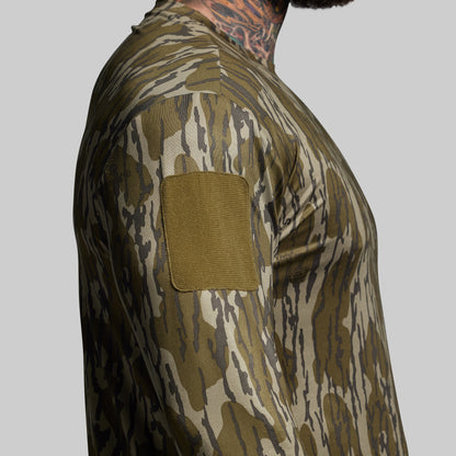 Camouflage shirt with a patch on a gray background