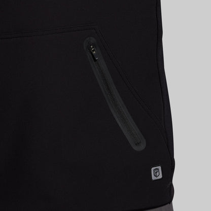 Close-up of a black jacket with a zipper and a brand logo on a light gray background