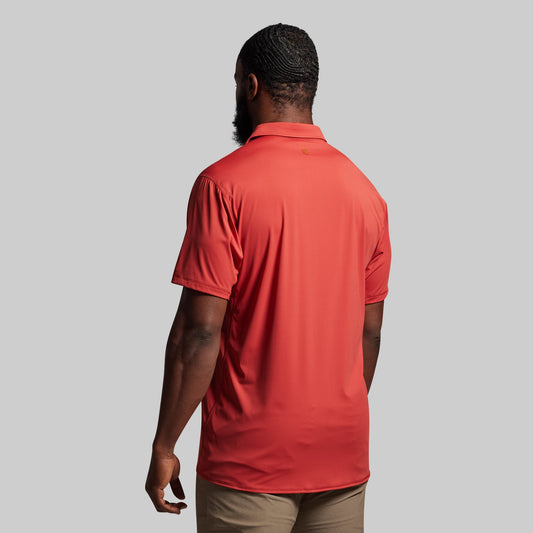 Person wearing a red polo shirt from the back.